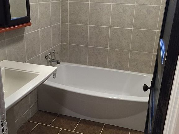 All new!
						:
						ceramic tile floor and surrounding tub!