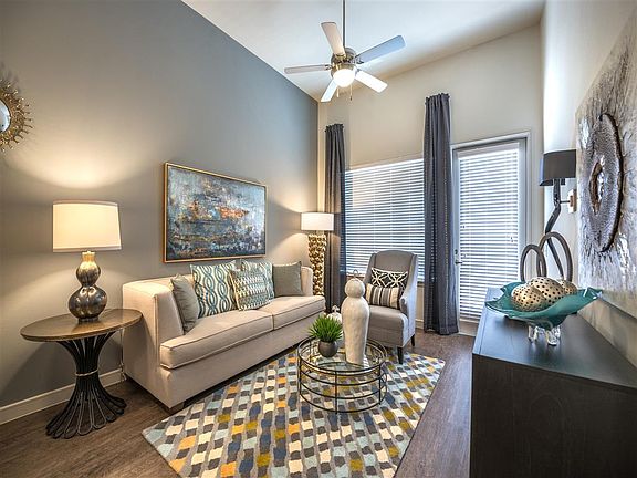 Spacious Living Room with Private Balcony on Select Apartments