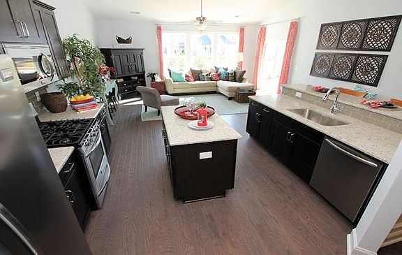 This is a model photo, the home will be available June 5. Amazing Island Kitchen with High end appliances! Envision your entertaining in this open floor plan!