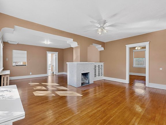 Living room looking into dining room with doorway to 2nd bedroom.