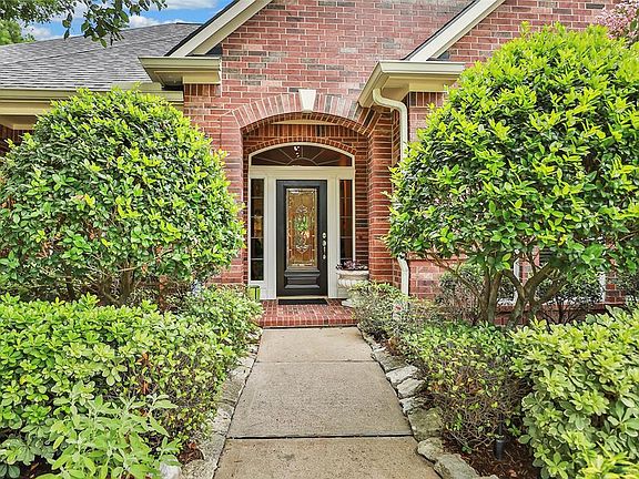 Sidewalk lined in stone brings you to a large covered front porch, a mahogany and etched glass front door with transom and sidelight glass.