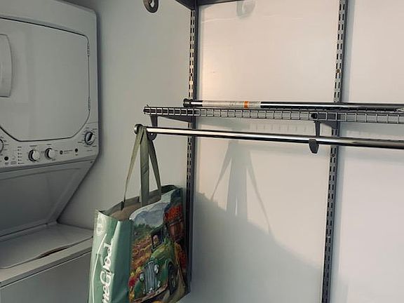 Closet with built ins and Washer/Dryer in residence