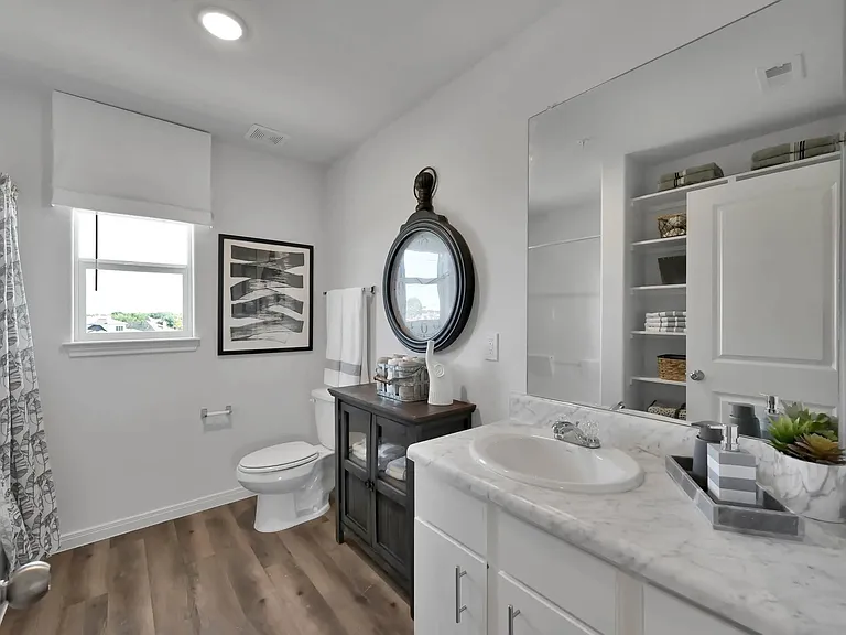 Experience modern living at Esperanza at Wild Orchid. This beautifully designed bathroom features elegant fixtures, ample storage, and a serene ambiance. Elevate your lifestyle in a space that combines comfort and style. Schedule your tour today!