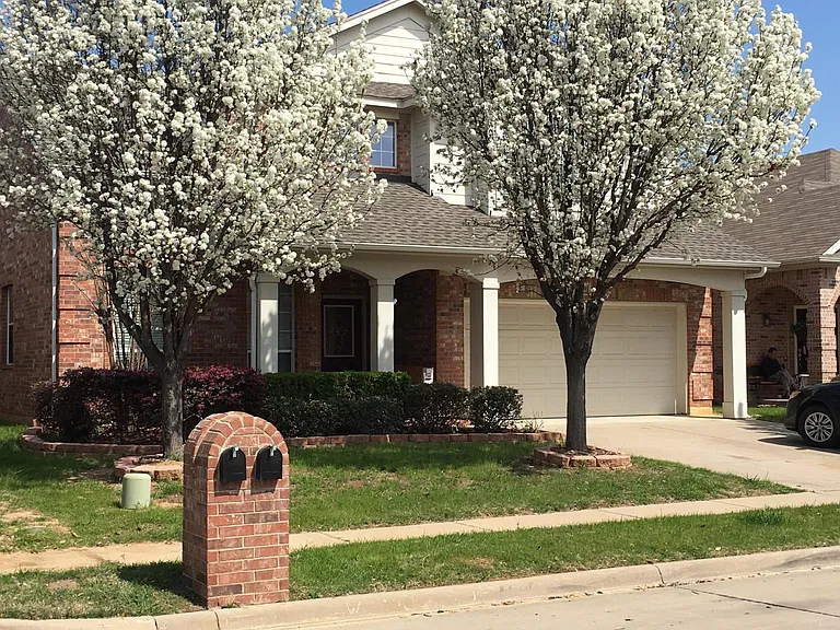 Nicely landscaped front yard and wide driveway.