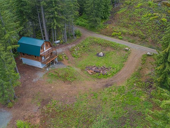 Aerial shot of cabin and a portion of the land. 