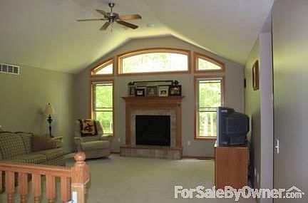 Living Room
						:
						Gas fireplace surrounded by windows to enjoy the wooded back yard from indoors.