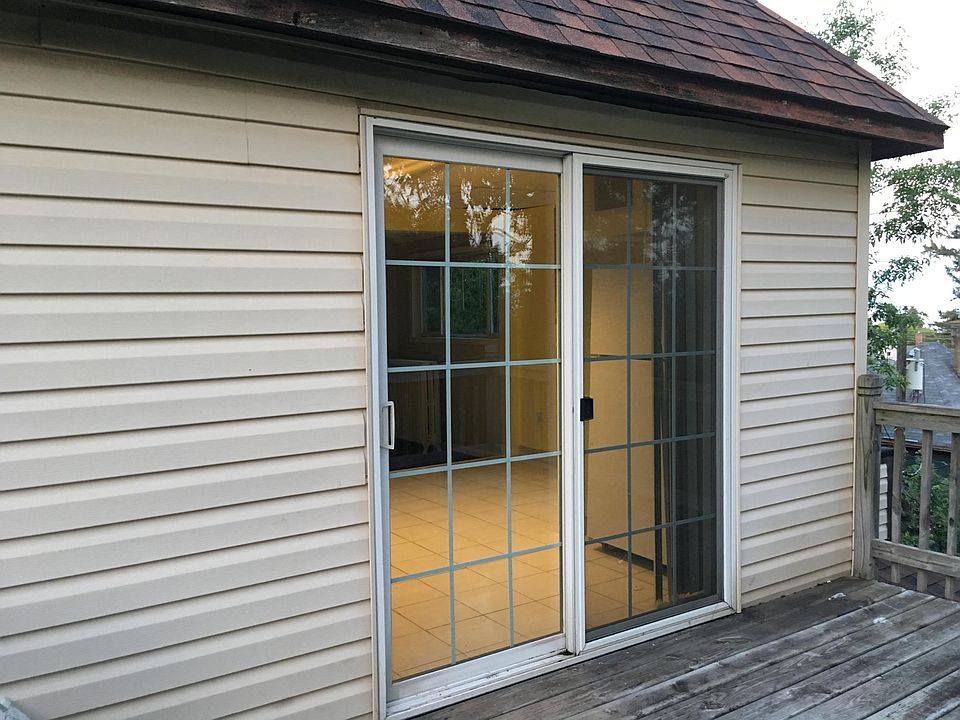 Patio door to deck overlooking back and side yard