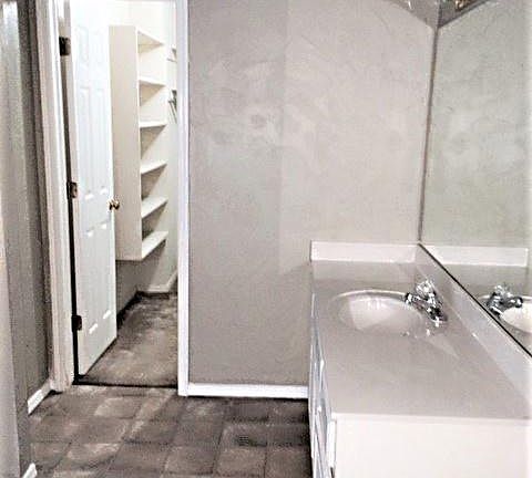 master bath-repainted solid light color, flooring replaced with vinyl plank tile