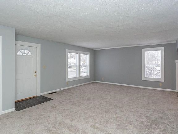 Generous Living Room offers brand new carpeting and plenty of space for furniture!