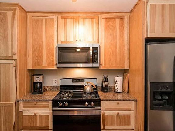 Kitchen has new appliances and cabinets.