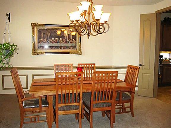 Dining room features picture frame chair rail, double crown molding and rope lighting.