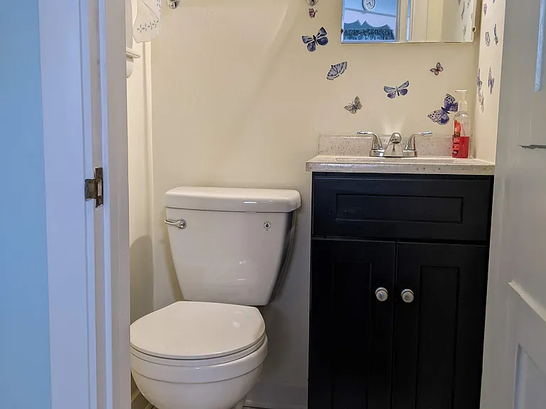 At the top of door to basement and off the kitchen, and right inside from upper garage