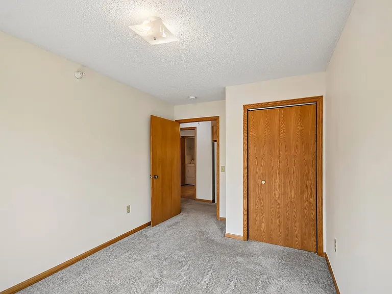 Step into comfort at Mill Pond Apartments. This spacious bedroom features soft carpeting, natural light, and ample closet space, perfect for relaxation. Explore your new oasis today. Schedule your tour now!