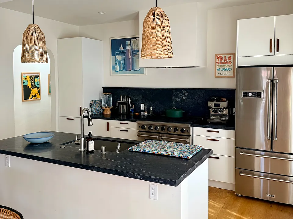 The kitchen features Nero marble countertops, new appliances (including a dishwasher), and ample storage.