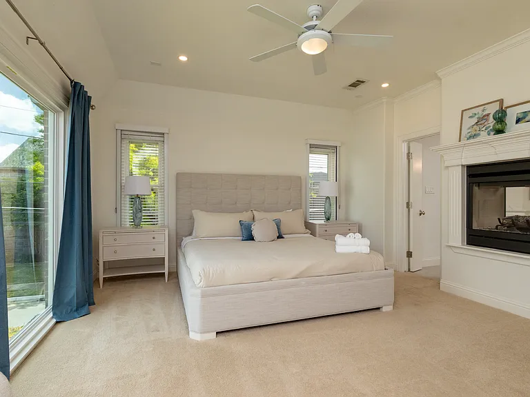 Luxurious master suite with a king bed and private fireplace.