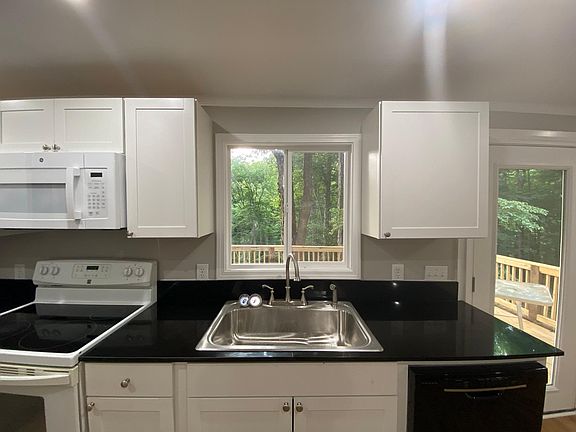 Windows and French door overlook wooded ravine