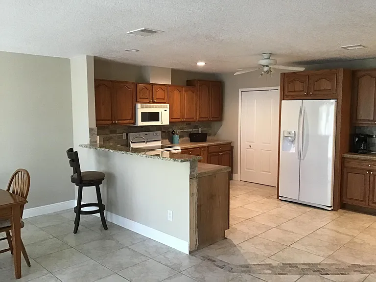 Looking at kitchen area from living room. Bifold doors lead to laundry rm/pantry