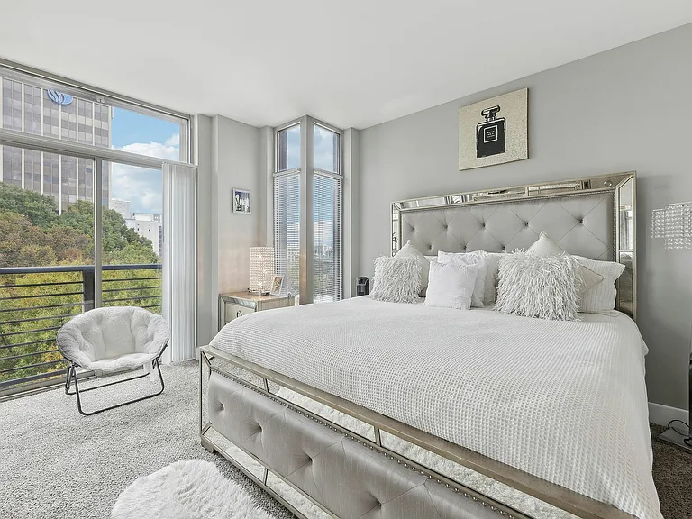 Bedroom with floor-to-ceiling windows and city views