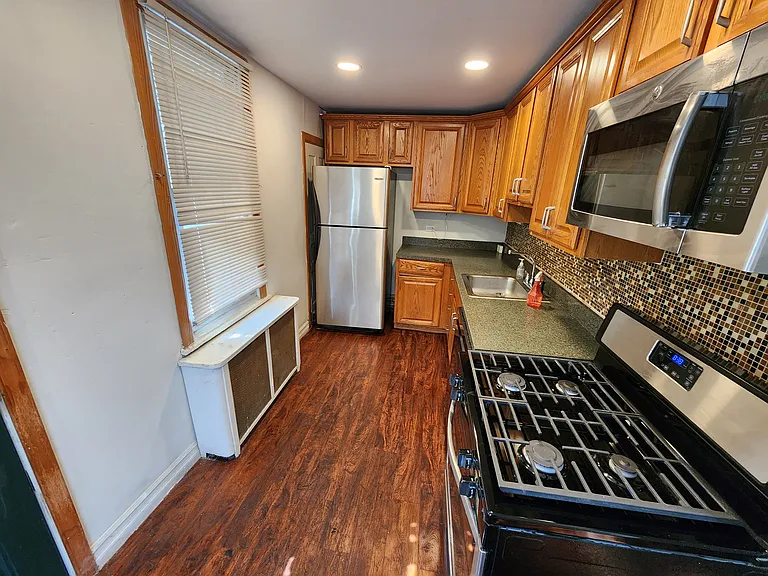 kitchen layout is efficient with new stainless appliances and enough room for multiple people to cook!
