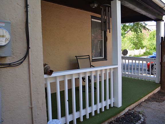 Covered side porch with fenced-in yard