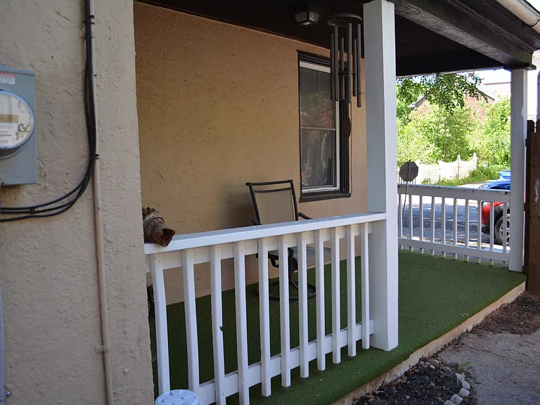 Covered side porch with fenced-in yard