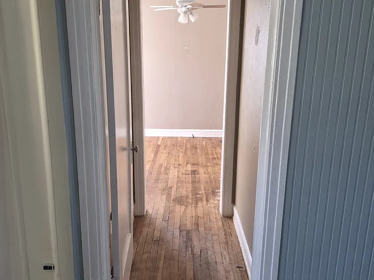 From Living room into bedroom. HVAC and hot water heater in a hall closet to the left.