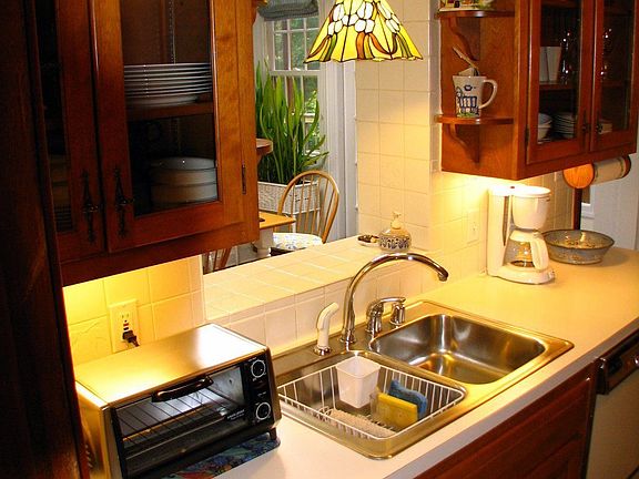 Kitchen with wood cabinets & glass doors