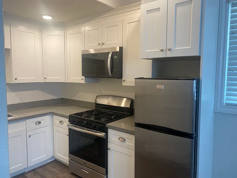 Full gas oven/range and microwave hood. Large solid wood cabinets and quartz counters. Luxury Vinyl plank floors.