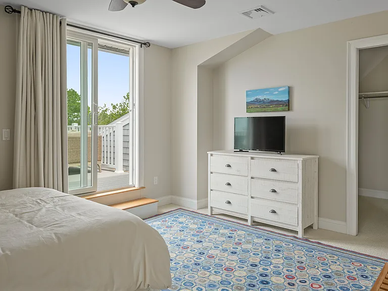 the third floor master bedroom adjacent to the sunbathing deck