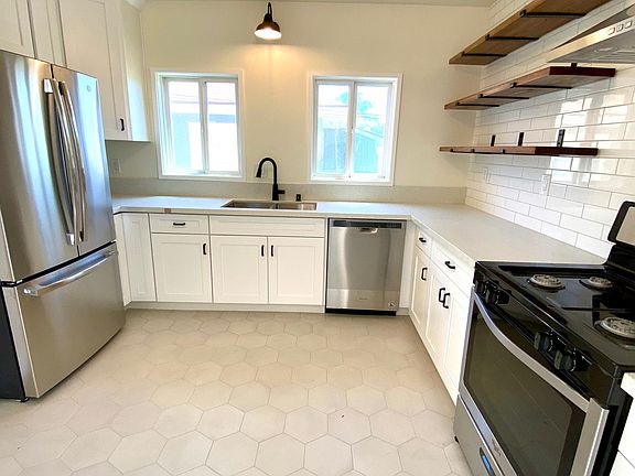 Shaker cabinets, quartz counters, custom shelves, newer appliances