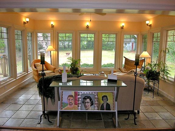 Vaulted Sunroom with Romantic Lighting and Deck & Patio Access.