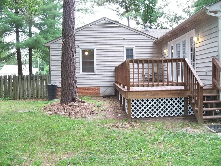 Fenced rear yard with deck