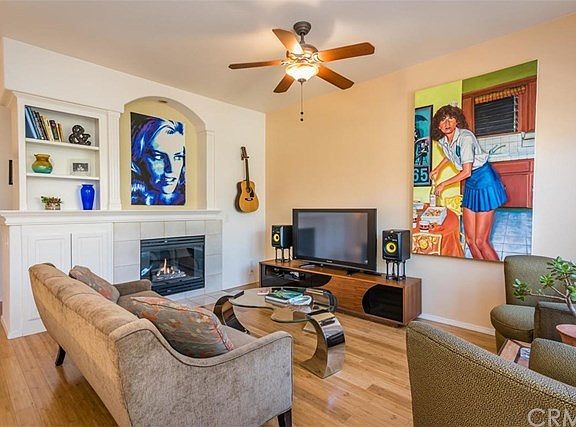 Living room features a gas burning fireplace and built in bookcases.