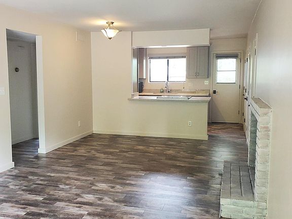 Living room with fireplace, dining room and kitchen
