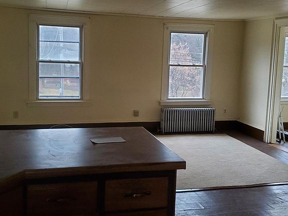 Looking from kitchen into living room, which is at the front of the apt. Door to right is from living room to the hall area with 3 windows.