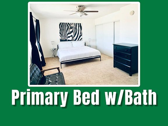 The primary bedroom is a spacious and serene retreat, complete with a comfortable bed, large closet space, and an ensuite bathroom. The neutral color palette and simple decor contribute to a relaxing and restful atmosphere.