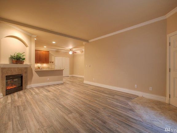 Electric fireplace, upgraded laminate throughout! Kitchen with eating bar & dining area.