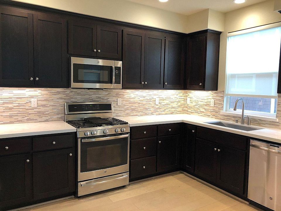 Kitchen with under-cabinet lighting, convenient outlets and a lot of counter space.