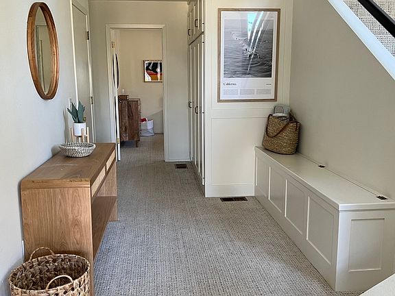 Foyer, 2 guest bedrooms ahead, staircase up on the right