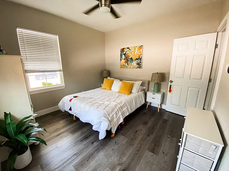 Comfortable front bedroom with great natural light, ceiling fan, closet space, and plenty of room to create a relaxing retreat.