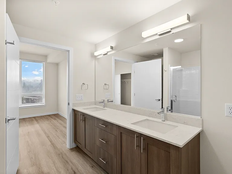Dual-sink vanity with plenty of storage and a seamless connection to the bedroom. Dual-sink vanity with plenty of storage and a seamless connection to the bedroom.