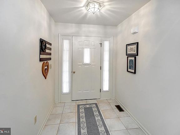 wide tile floored entry foyer; sidelight door