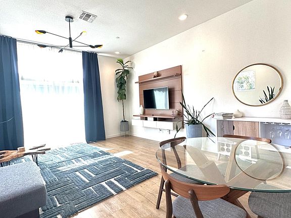 Large sliding glass doors and transom windows bring in natural light.