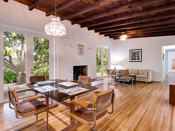 Notice the large Latin fruit tree and patio opening from the dining area French doors.