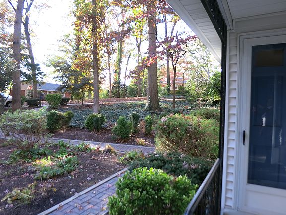 The front has paved brick walkways & stone walls.