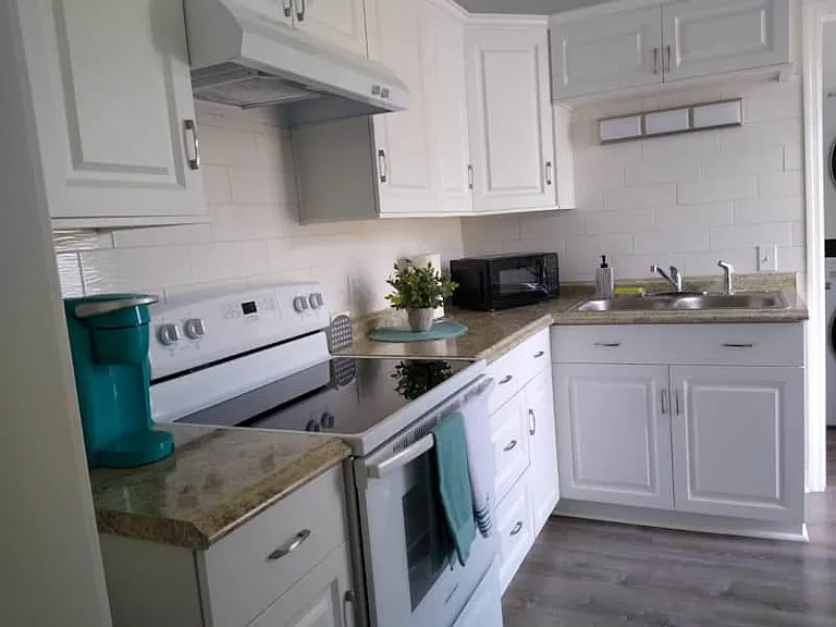 Fully equipped kitchen with stove, cabinets, and essential amenities.