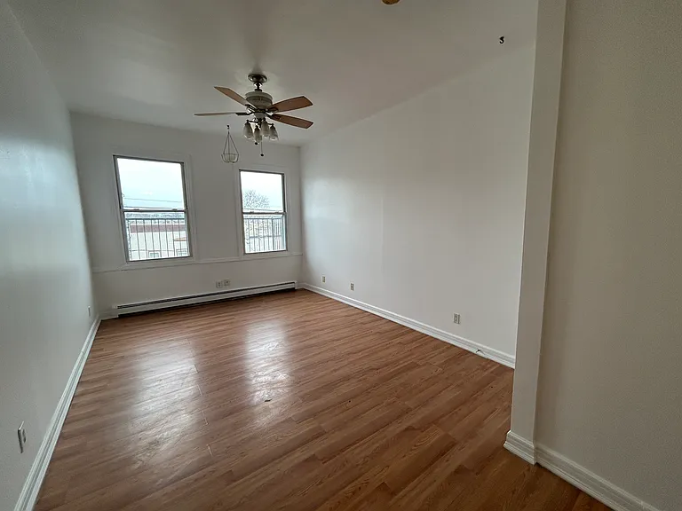 Livingroom with ceiling fan and natural light