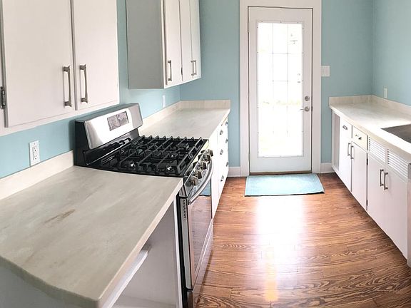 Light and clean updated kitchen. New stove, microwave, dishwasher, large refrigerator. Door opens to fenced backyard.