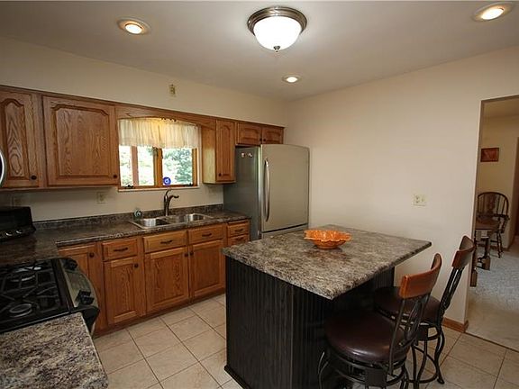 Plenty of Wood Cabinets in Updated 11x10 Eat-in Kitchen Freshly Painted w/ Island Breakfast Bar. Stainless Steel Refrigerator, G