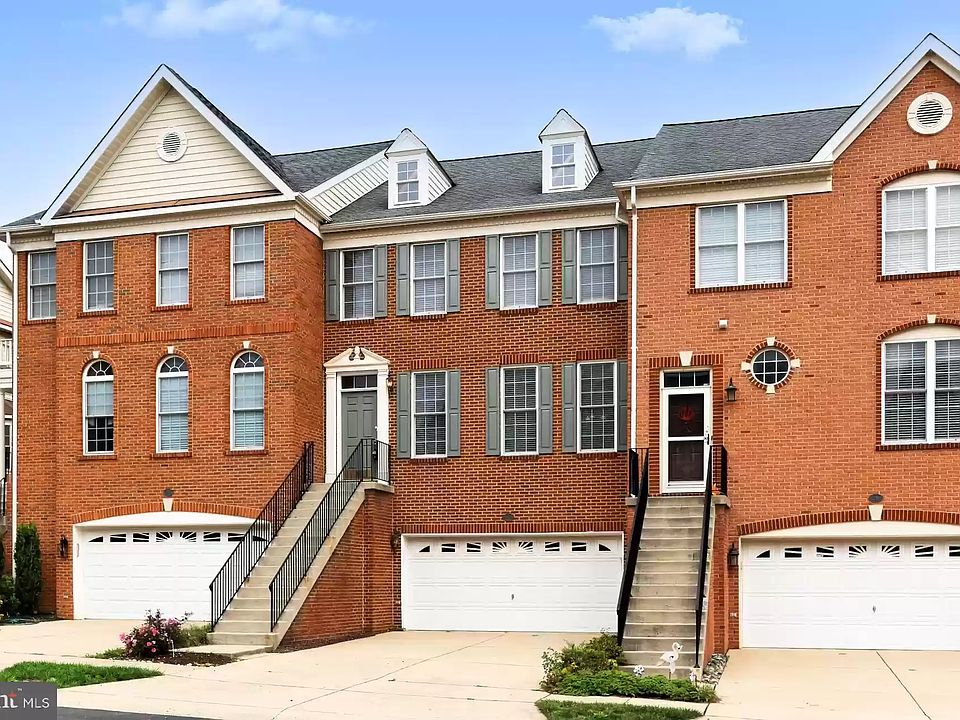 Beautiful red brick elevation with a large 24 feet wide two-car garage and lots of windows.